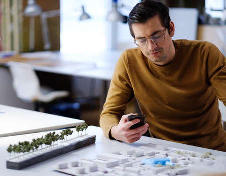 Man working in design and engineering architecture office.の写真素材