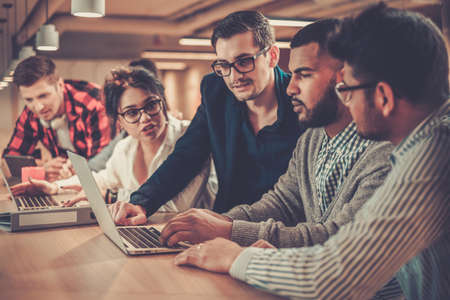 Young colleagues discussing ideas in coworking office.の写真素材