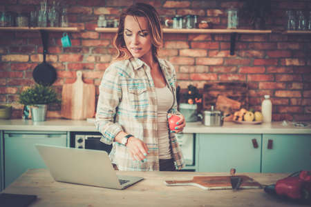 Cheerful woman looking online recipe.の写真素材