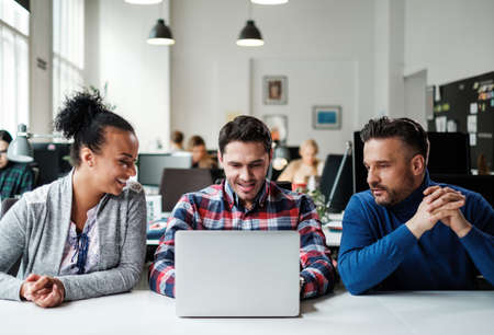 Multi-ethnic colleagues in a coworking office.