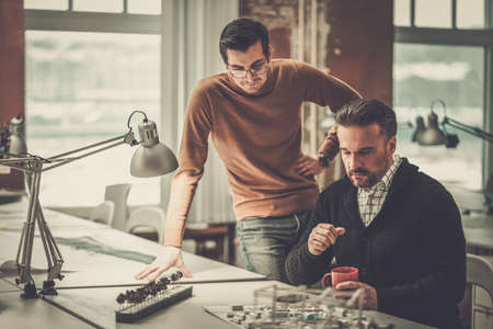 Two men working in design and engineering architecture officeの写真素材