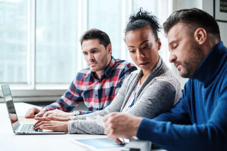 Multi-ethnic colleagues in a coworking office.の写真素材