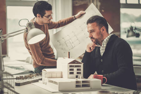 Two men working in design and engineering architecture officeの写真素材