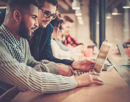 Young colleagues discussing ideas in coworking office.の写真素材