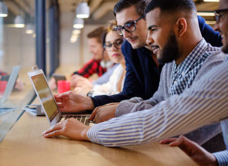 Young colleagues discussing ideas in coworking office.の写真素材