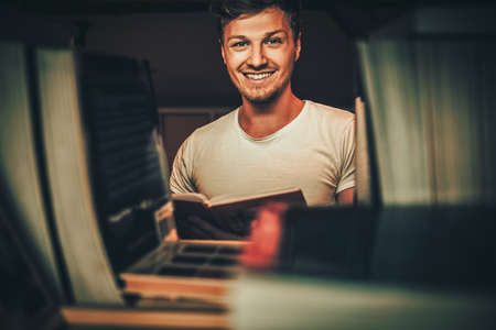 Young man in a library.の写真素材