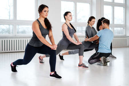 Group of young people doing fitness exercices.