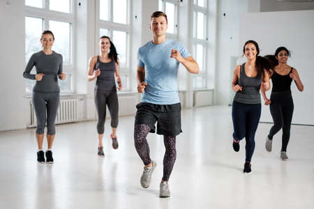 Group of young people doing fitness exercices.