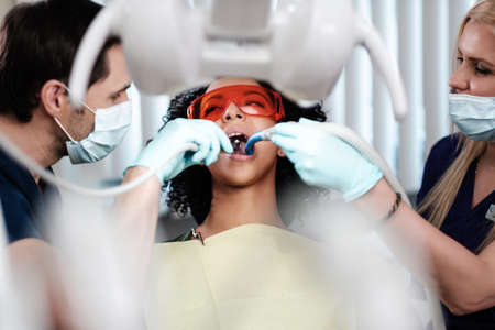 Dentist and his assitant working in private practice.