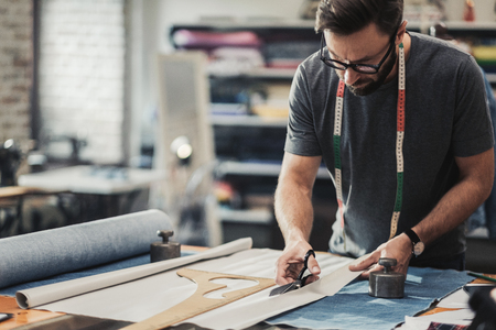 Fashion designer working in his studioの写真素材