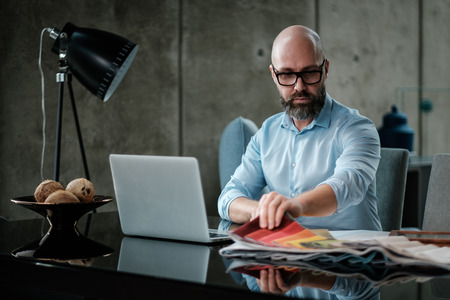 Middle-aged designer working in officeの写真素材