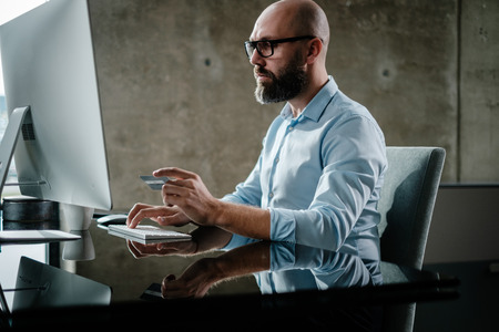 Middle-aged designer working in officeの写真素材