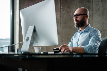 Middle-aged designer working in officeの写真素材