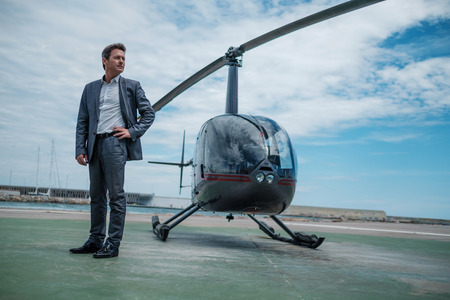 Businessman standing near private helicopterの写真素材