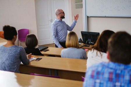 Lecturer and multinational group of students in an auditorium