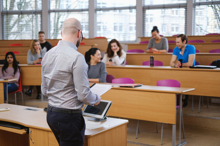 Lecturer and multinational group of students in an auditoriumの写真素材