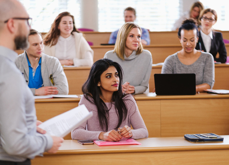 Lecturer and multinational group of students in an auditorium