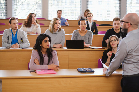 Lecturer and multinational group of students in an auditorium