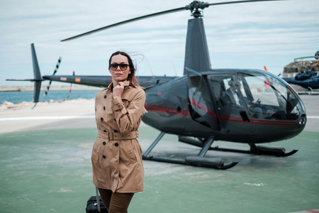Business woman near private a helicopterの写真素材