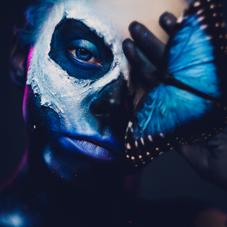 Beautiful woman with blue hair and butterfly