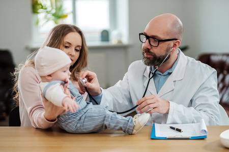 Mother with baby visiting pediatricianの写真素材