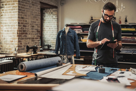 Fashion designer working in his studioの写真素材