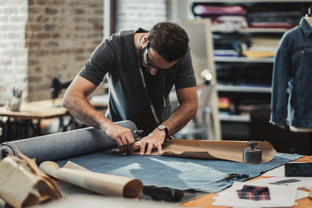Fashion designer working in his studioの写真素材
