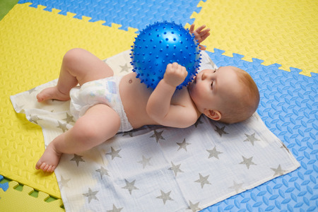 Baby boy getting massage with special equipmentの写真素材