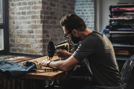 Fashion designer working in his studioの写真素材