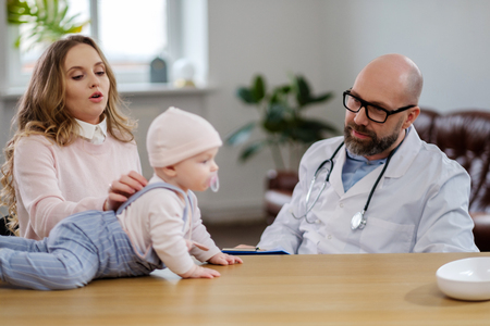 Mother with baby visiting pediatricianの写真素材