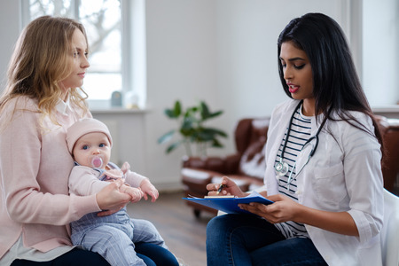 Mother with baby visiting pediatrician