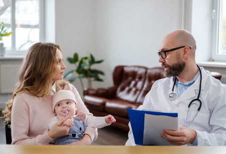 Mother with baby visiting pediatricianの写真素材
