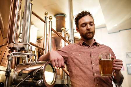 Man tasting fresh beer in a brewery
