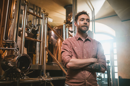 Man tasting fresh beer in a breweryの写真素材