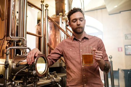Man tasting fresh beer in a breweryの写真素材
