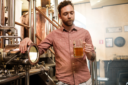 Man tasting fresh beer in a brewery