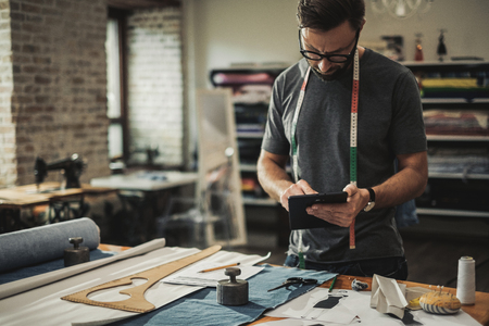 Fashion designer working in his studioの写真素材