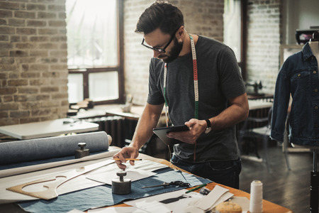 Fashion designer working in his studioの写真素材