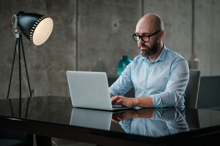Middle-aged designer working in officeの写真素材