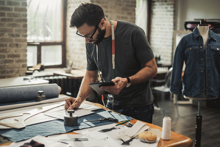 Fashion designer working in his studioの写真素材