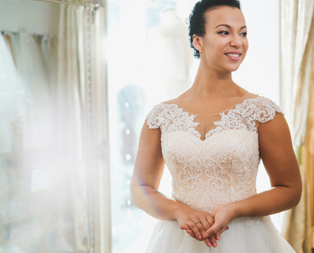 Beautifu bride choosing wedding dress in a wedding salonの写真素材
