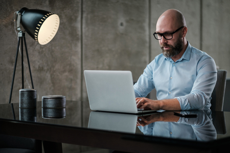Middle-aged designer working in officeの写真素材