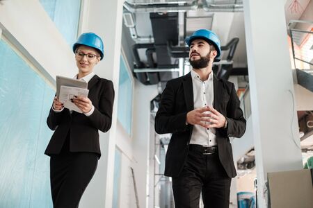 Engineers in hardhats have conversationの写真素材