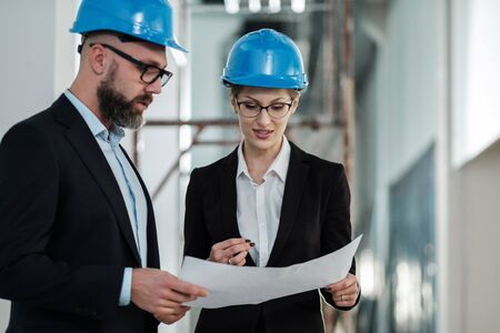 Engineers in hardhats have conversationの写真素材