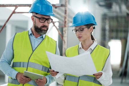 Engineers in hardhats have conversationの写真素材