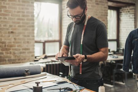 Fashion designer working in his studioの写真素材
