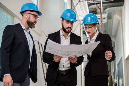 Engineers in hardhats have conversationの写真素材