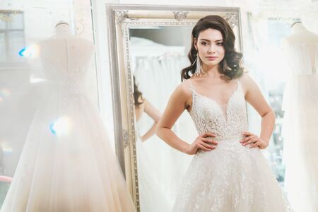 Beautifu bride choosing wedding dress in a wedding salonの写真素材