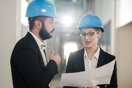 Engineers in hardhats have conversationの写真素材