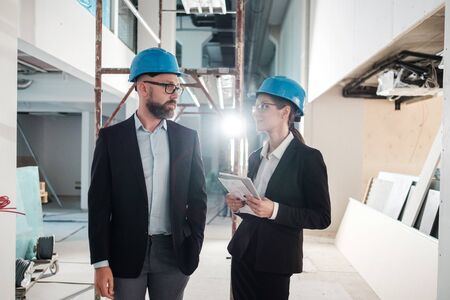 Engineers in hardhats have conversationの写真素材